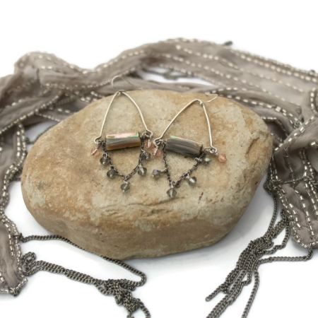 Elegant eclectic earrings on rock with scarf