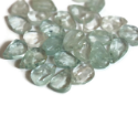 loose aquamarine stones on white