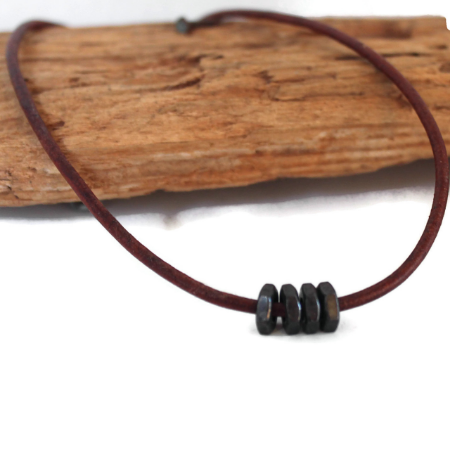 black-hex-nut-brown-leather-men's-necklace-on-wood-on-white-background