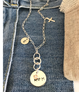 Sterling-multi-chain-mom-charm-necklace-on-denim-background