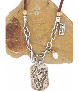 bronze heart necklace on rock