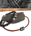 leather necklace beaded bracelet on rock