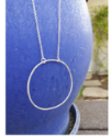 silver circle necklace on blue pot