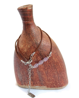 light amethyst leather necklace on brown vase