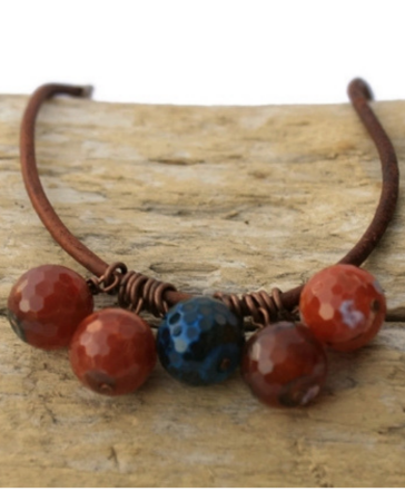 red/blue gemstone leather cluster necklace on wood