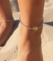 yellow stone chain anklet on foot at beach