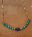 blue and green gemstone necklace on wood