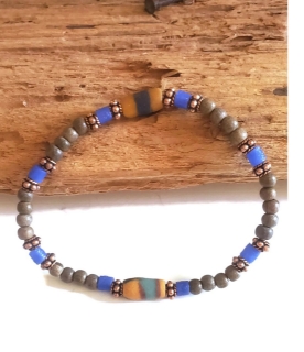 a mix of neutrals & bold color beaded bracelet on wood