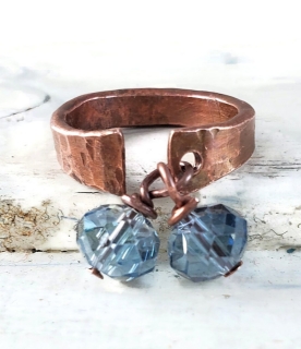 hammered copper cuff ring with blue crystals on white distressed wood