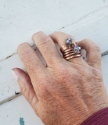   wearing a copper coil and blue crystal copper ring stack