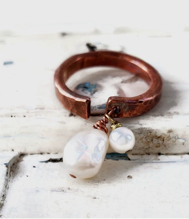 White freshwater pearl copper cuff ring on white distressed wood