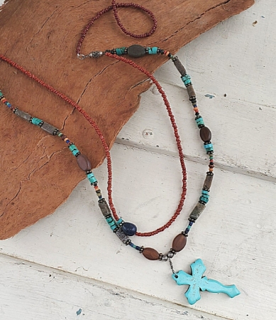 Displayed on wood layered earthy gemstone cross necklace