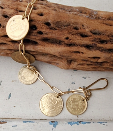 gold coin chain charm bracelet on wood