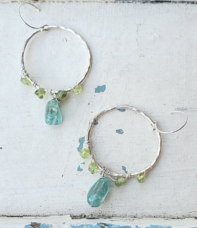 Silver hoop chandelier blue green gemstone earrings on white distressed wood