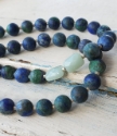 blue and aqua gemstones on white distressed wood