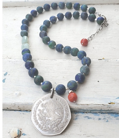 1977 silver Mexican coin  vibrant gemstone necklace full view on white wood