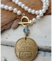 White pearl-gold-Finland coin necklace on wood