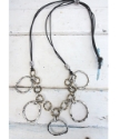 Artisan mixed metal chain cluster necklace on white distressed wood
