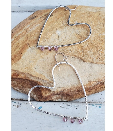 Handcrafted silver open heart earrings on stone