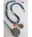 Blue red aqua gemstone coin necklace on white trunk