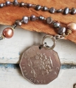Silver Jamaica coin pearl necklace on wood