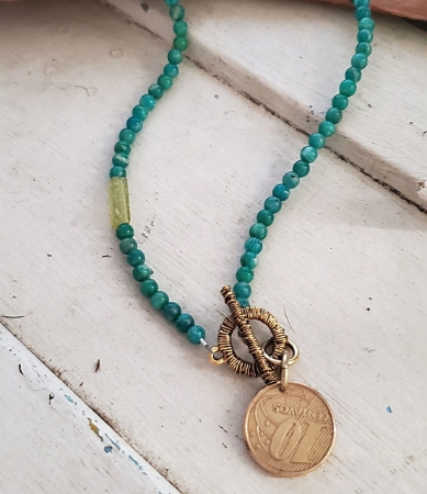 Turquoise & green beaded Brazil coin necklace on white wood