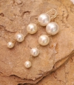 long white graduating pearl earring on stone