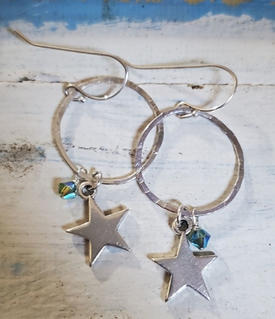 Silver Star hoop crystal earrings on white wood