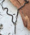 silver stone black chain necklace on wood