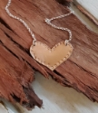handcrafted bronze heart silver chain necklace on wood