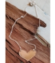 bronze heart silver chain necklace on wood