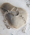 sterling-silver open-heart bracelet on rock