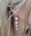 white pearl graduated earrings on female side view