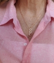 Wearing bronze family tribe necklace with pink blouse