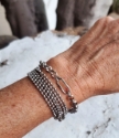 silver chunky multi chain modern bracelets on wrist