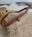 brown leather brass bead choker necklace at angle on rocks