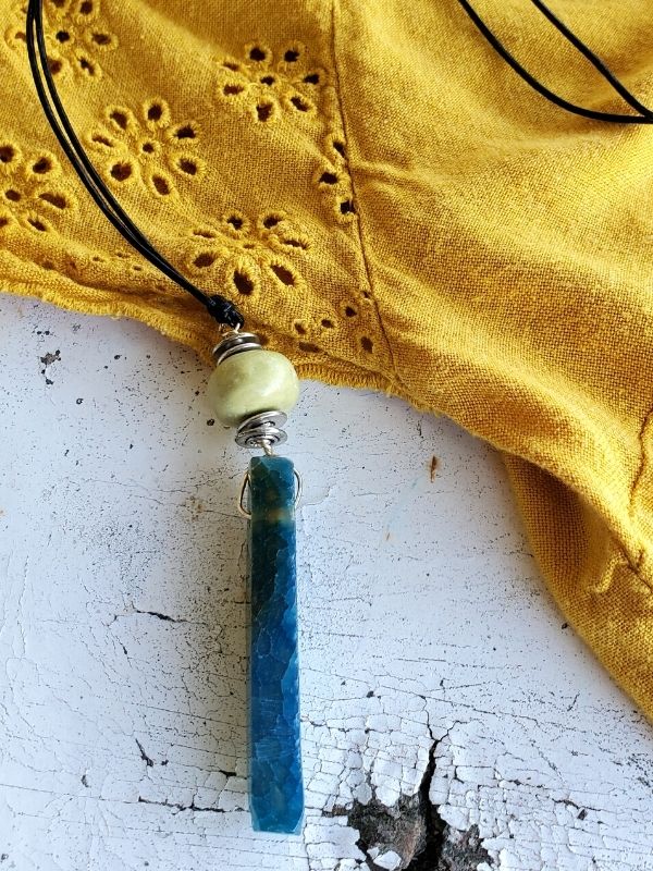 green & teal stick necklace with yellow dress