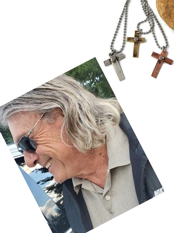 man wearing cross necklace
