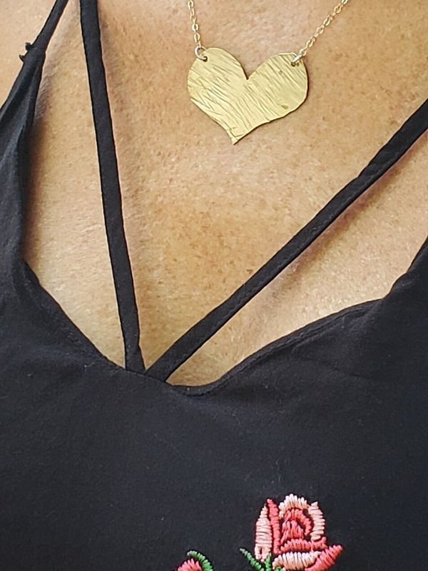 black strap top with gold heart necklace