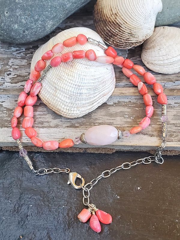 pink coral gemstone necklace/bracelet on seashells