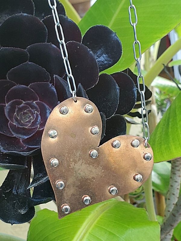 riveted copper heart necklace in the garden