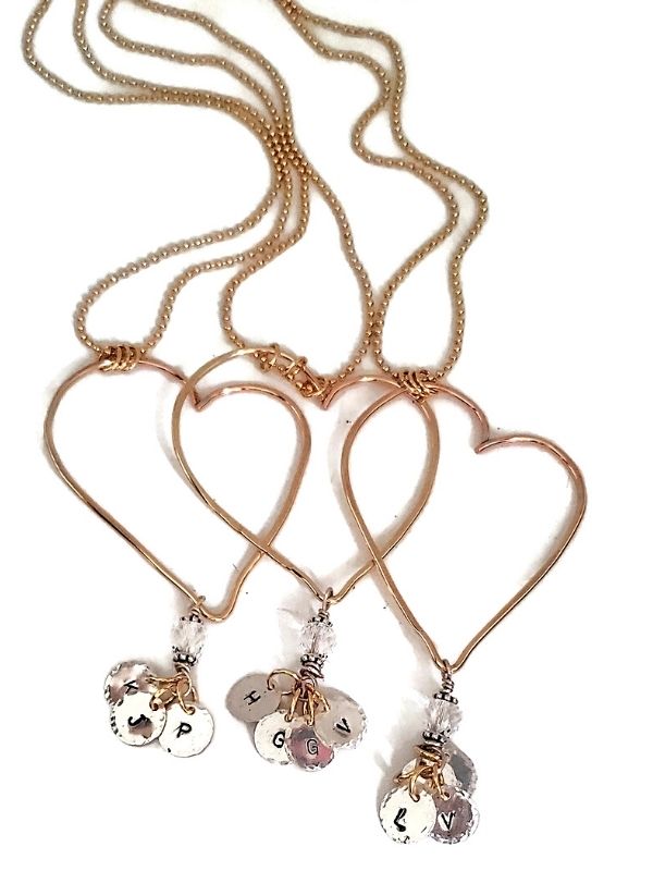 gold  open heart necklaces in a row on white background