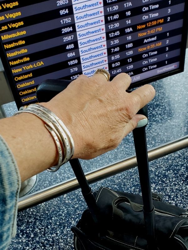 silver cuffs on arm at airport