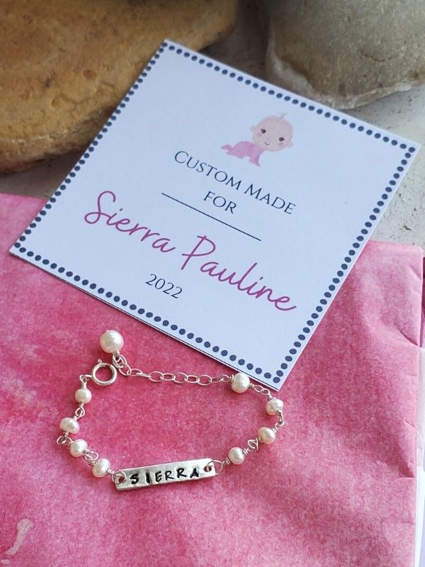 pearl baby bracelet on pink tissue w/card insert